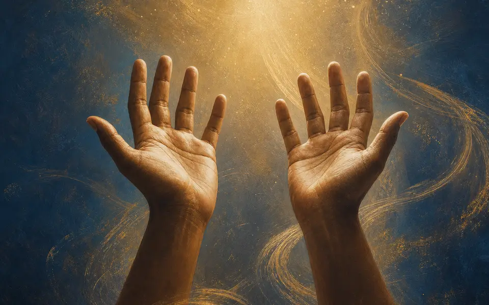 Hands raised in worship toward warm golden light